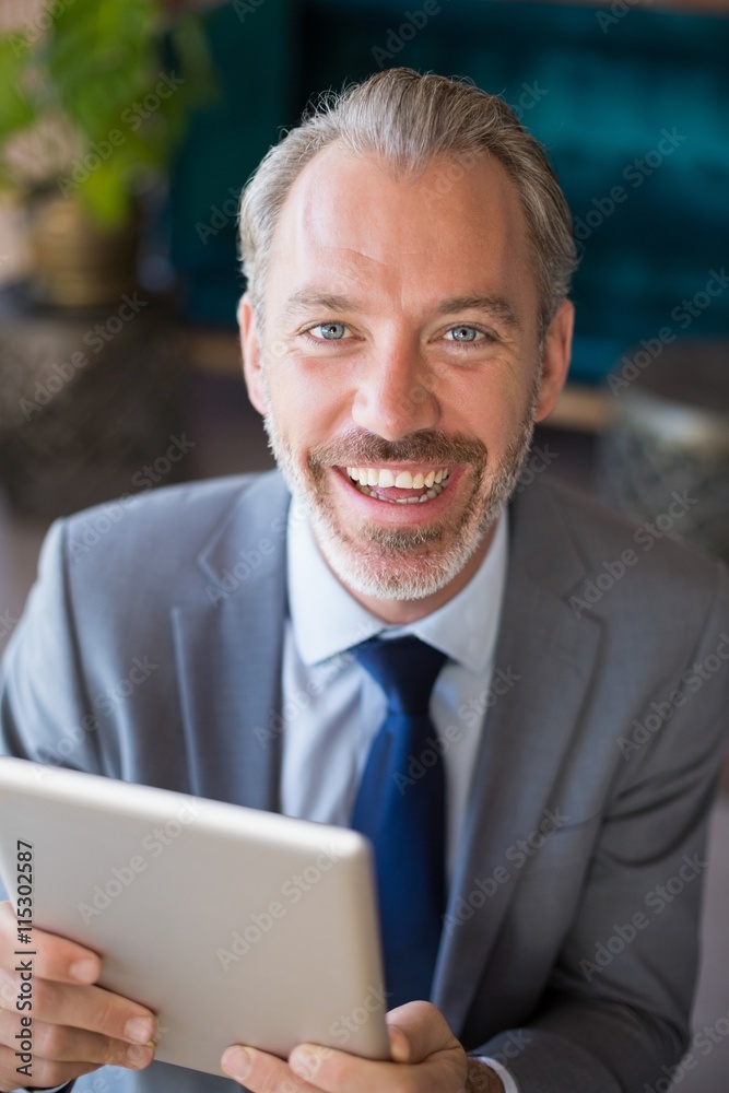 Businessman using digital tablet in café Businessman using digital tablet in café