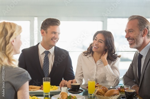 Business people having meal in restaurant photo