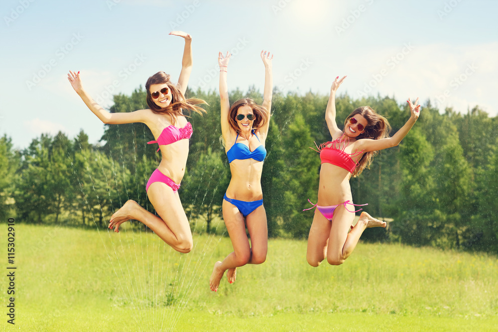 Group of women in bikin having fun outdoors Group of women in bikin having fun outdoors