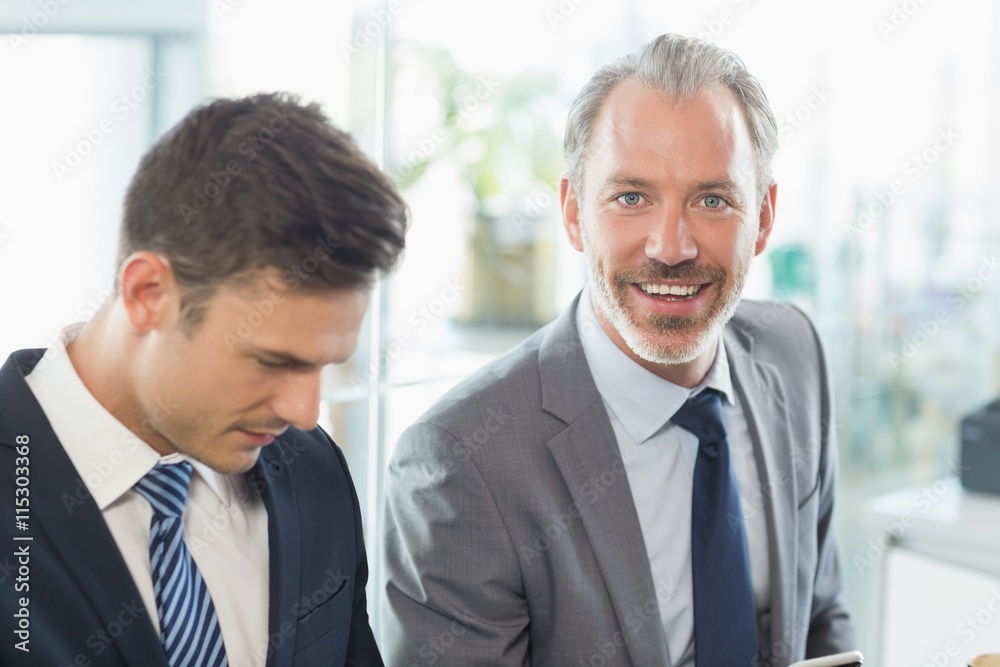 Two businessmen sitting with each other Two businessmen sitting with each other