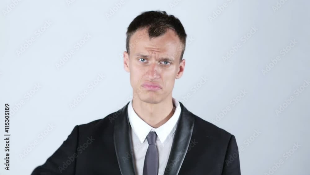Disappointed young business man with thumb down Disappointed young business man with thumb down