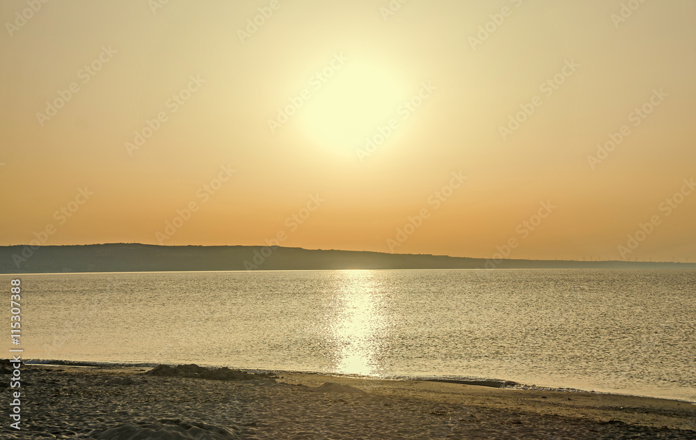 Sunrise on seaside, sand and clear water, the shore of Black Sea Sunrise on seaside, sand and clear water, the shore of Black Sea