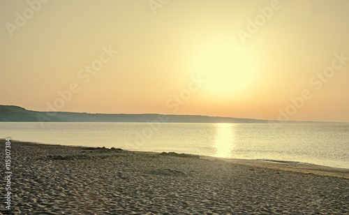 Sunrise on seaside, sand and clear water, the shore of Black Sea