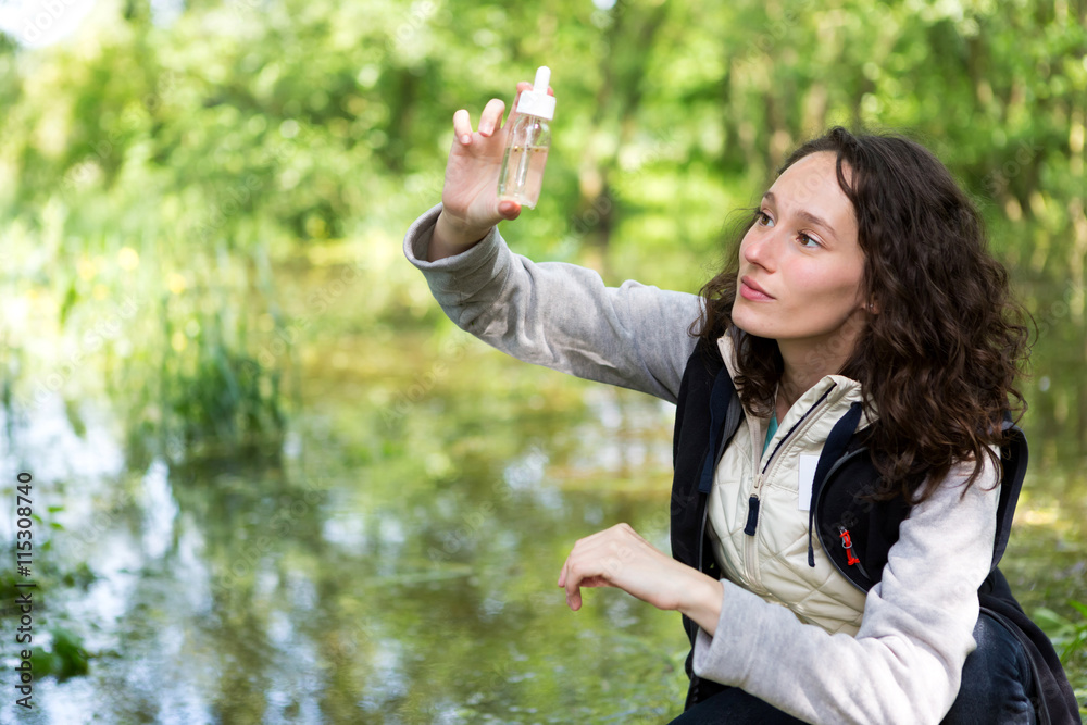 Young attractive biologist woman working on water analysis Young attractive biologist woman working on water analysis