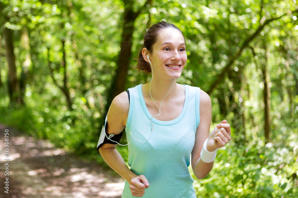 Young attractive woman running in the forest Young attractive woman running in the forest