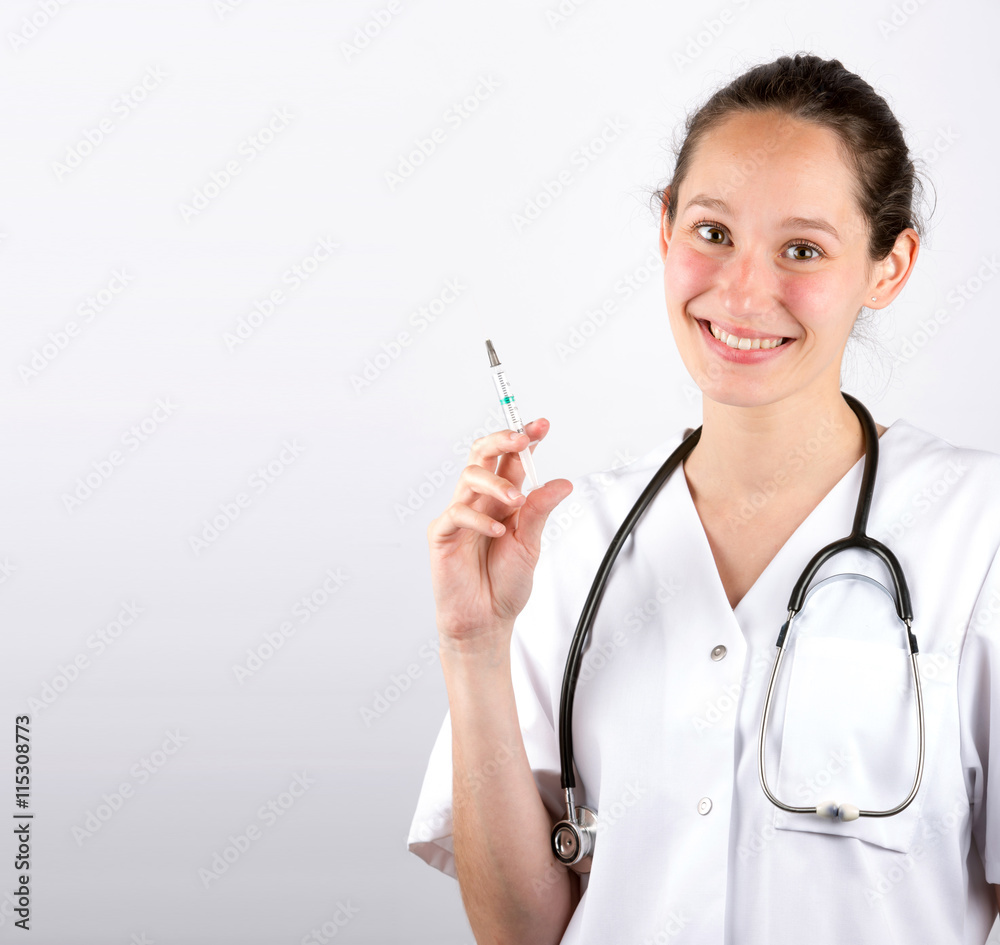 Smiling medical doctor woman with stethoscope on a white backgro Smiling medical doctor woman with stethoscope on a white backgro