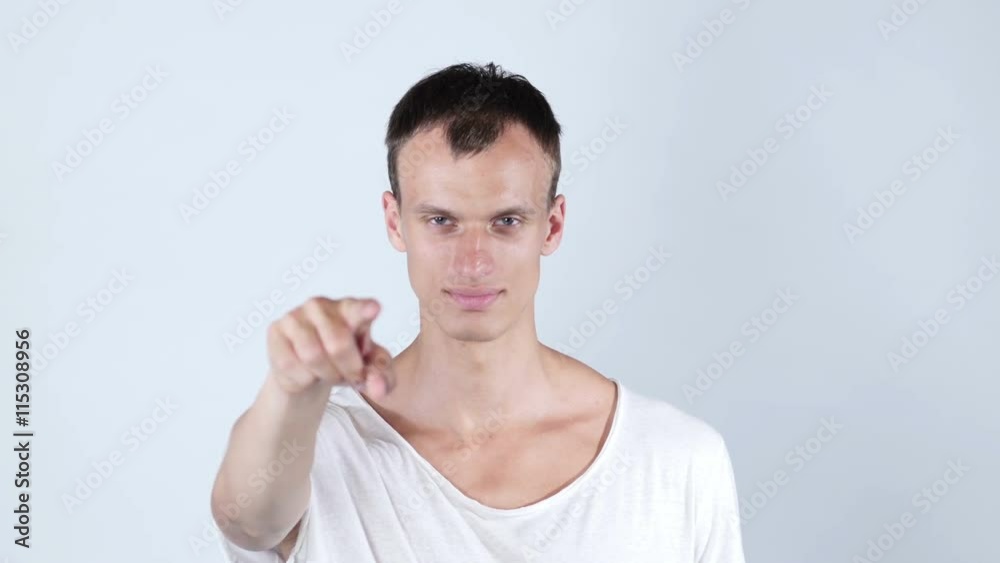 Portrait of a young man pointing his finger at you Portrait of a young man pointing his finger at you