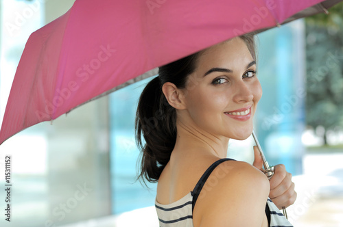 Woman goes under an umbrella