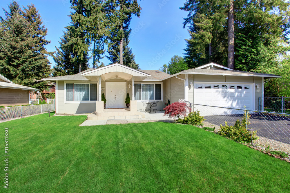 Curb appeal of beige house with well kept lawn and garage Curb appeal of beige house with well kept lawn and garage
