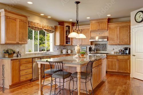 Classic American kitchen inerior with brown cabinets and granite counter top