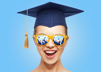happy teenage girl in shades and mortarboard hat