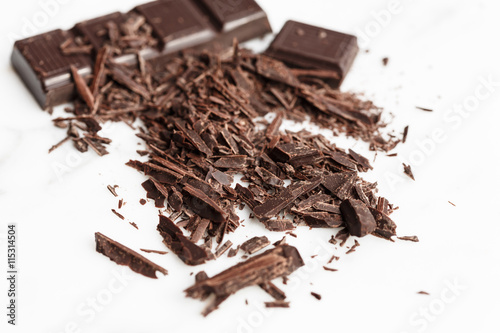 Chopped dark chocolate on white background