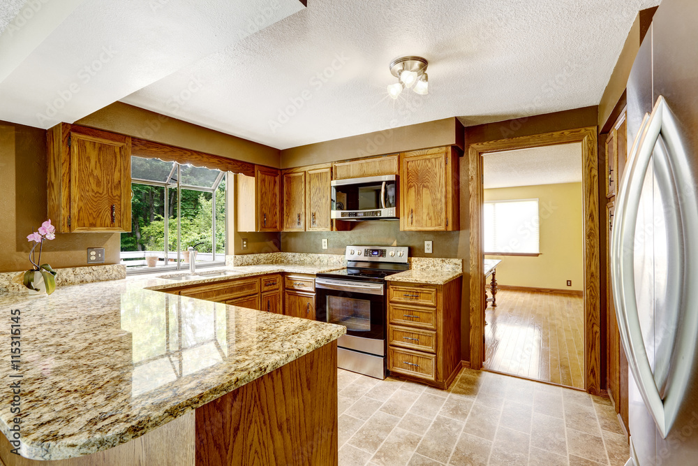 Kitchen interior with wooden cabinets and granite counter top Kitchen interior with wooden cabinets and granite counter top