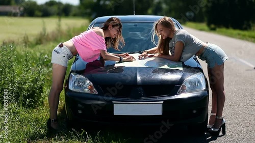 women on vacation looking at map for directions