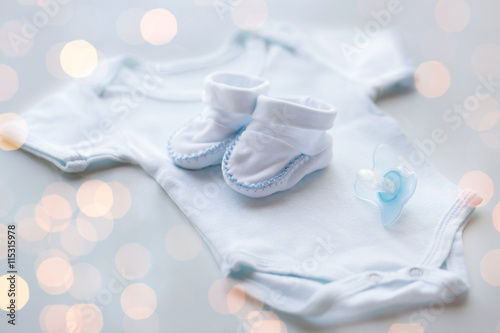 close up of baby boys clothes for newborn on table