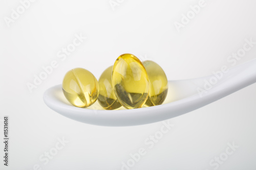 Omega 3 pills on a spoon.