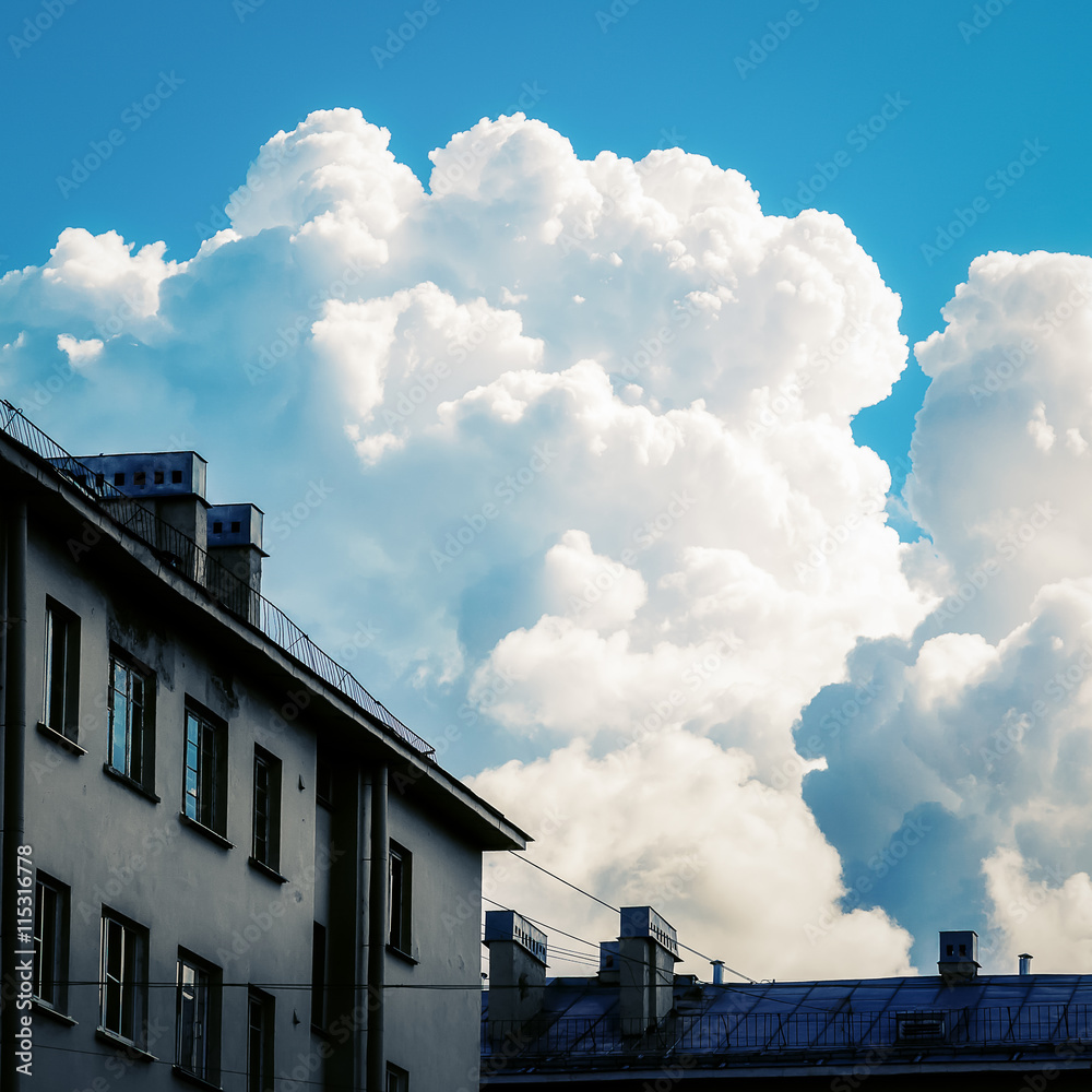 Blue sky with clouds over the houses Blue sky with clouds over the houses