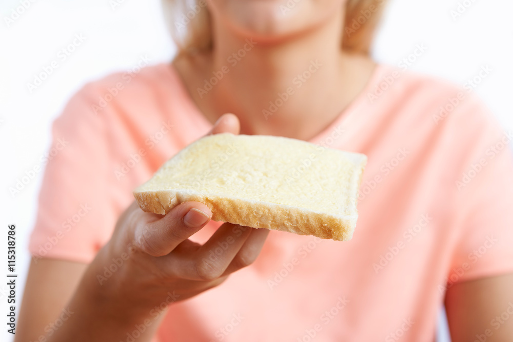 Woman Eating Slice Of White Bread With Margarine Woman Eating Slice Of White Bread With Margarine