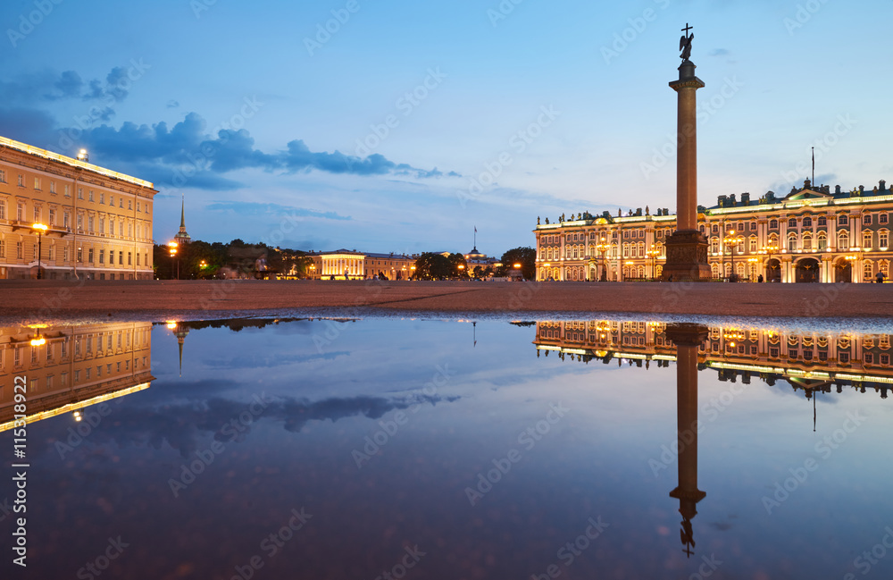 Russia, Saint-Petersburg, 03 July 2016: Palace Square with night illumination, Winter Palace, Hermitage, Alexander Column, reflection in a water pool after a rain, a lot tourists, sunset, water mirror
