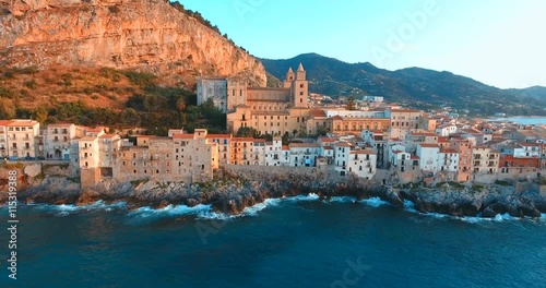 Picturesque historic town on a rocky headland at sunset photo