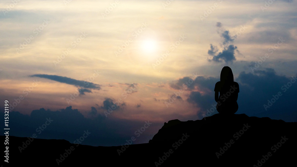 The silhouette of a single woman on the cliff