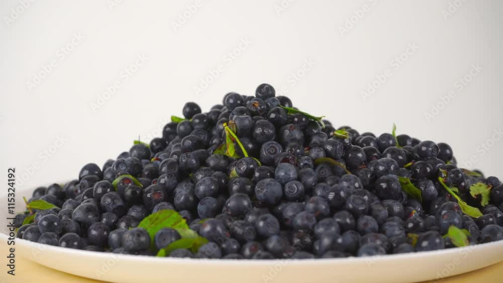 Pouring wet blueberries on a rotating plate 4K close up ProRes video Pouring wet blueberries on a rotating plate 4K close up ProRes video