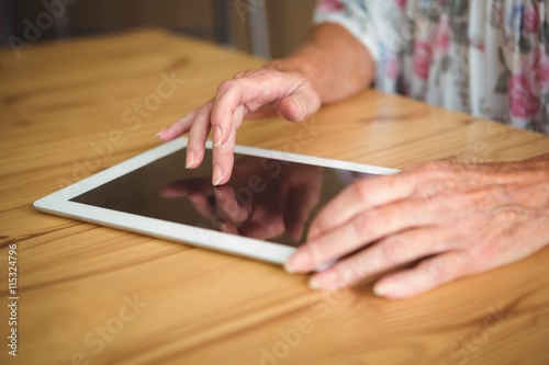 Old person touching a digital tablet