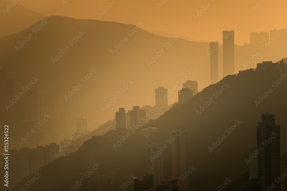 Silhouette high buildings on mountains