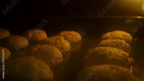 Baking buns in an oven shallow focus video photo