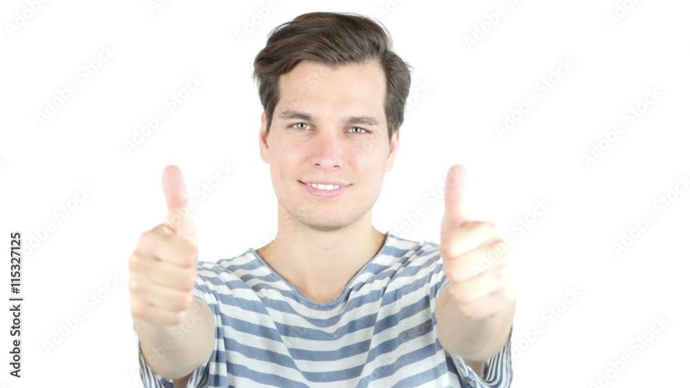 Closeup portrait of super happy, excited man in blue thumbs up w both hands Closeup portrait of super happy, excited man in blue thumbs up w both hands