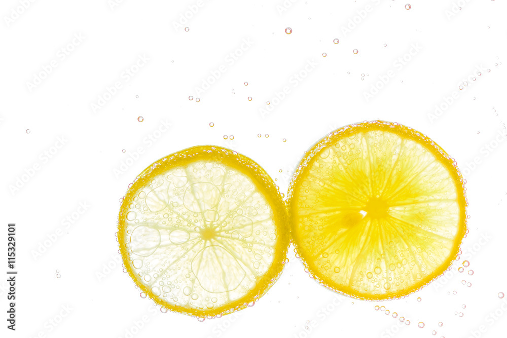 Fresh lemon slice in water with bubbles on white background Fresh lemon slice in water with bubbles on white background