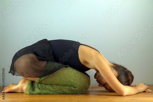 female dancer doing stretching for the back photo