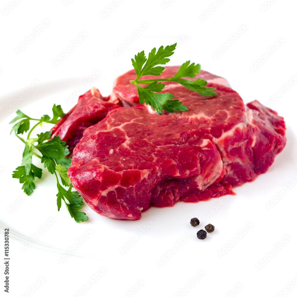 Raw beef fillet steak with sprig of parsley on white background, isolated
