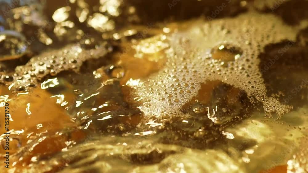 slow motion macro shot of eggs boiling in a pot