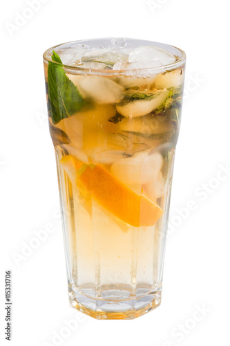 glass of cold fruit cocktail with ice, mint and pieces of fruit on a white background