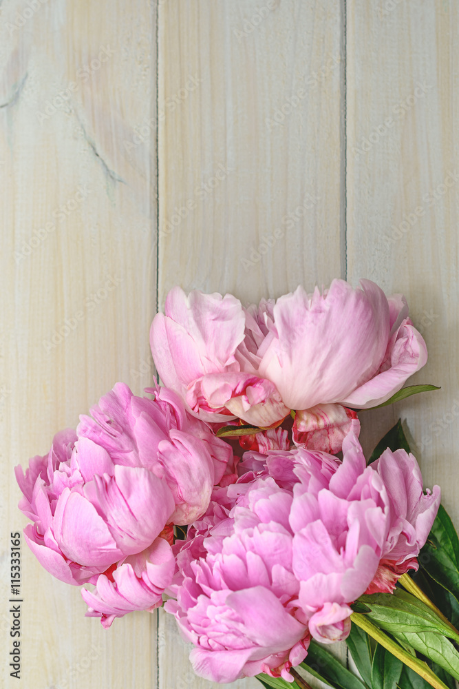 Naklejka Peony in all its splendor against a wooden background