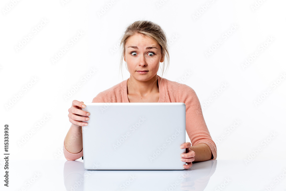 amazed young woman sitting at clean desk staring at computer amazed young woman sitting at clean desk staring at computer