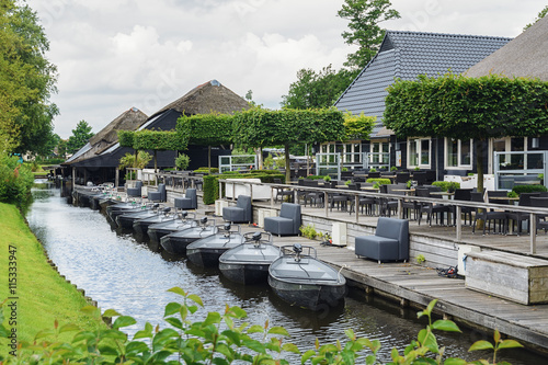 Grey pleasure boats moored to the quay