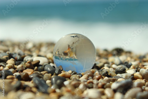 Glass earth on the beach