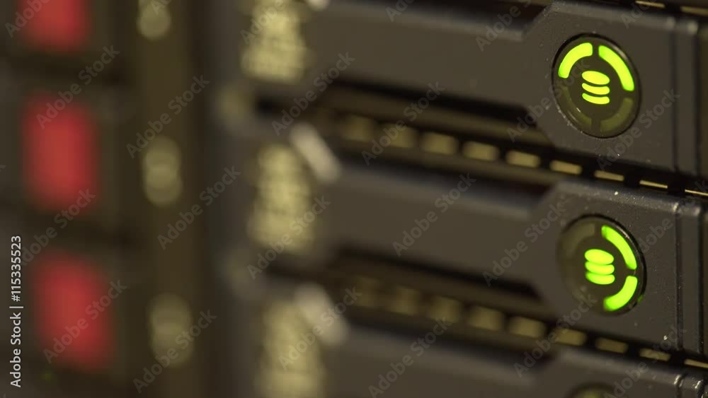 shallow depth of field hard drive lights blinking on a server shallow depth of field hard drive lights blinking on a server