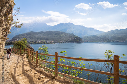 Cyclists run through the trail of Ponale in Riva del Garda, Italy.