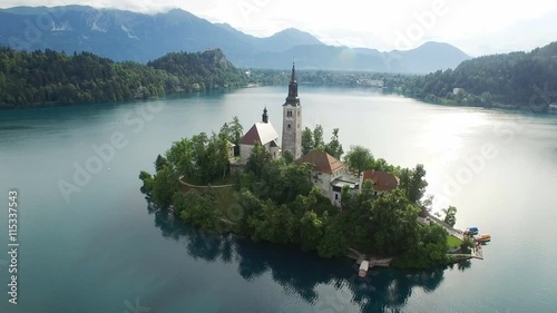 AERIAL VIEW: flight over Lake Bled in Slovenia .View of the Church of the Assumption of the Virgin Mary
