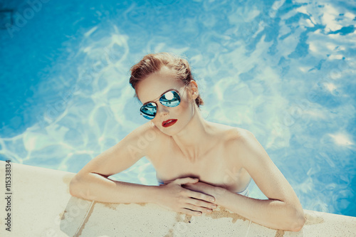 Beautiful brown hair woman near water wearing bikini.