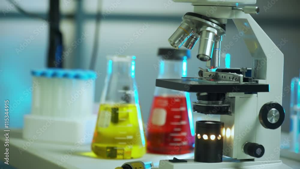 Scene moves slowly around a scene of a microscope and other laboratory paraphernalia. Scene moves slowly around a scene of a microscope and other laboratory paraphernalia.
