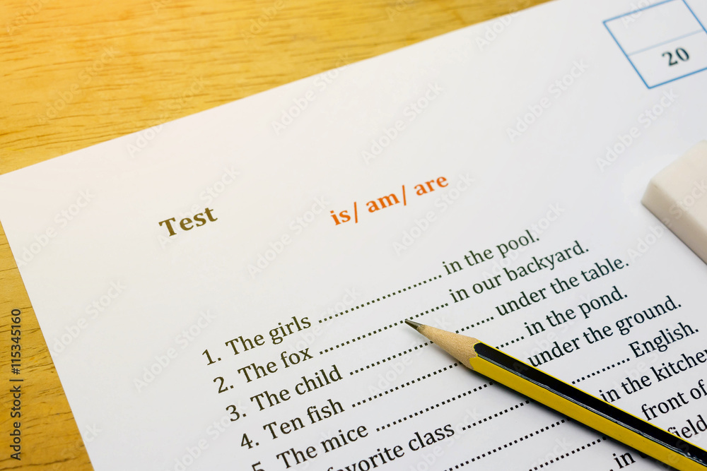 english test on brown wooden desk with gradient light english test on brown wooden desk with gradient light