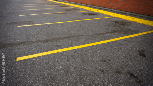 Wallpaper Mural An empty parking spot with yellow lines beside the building Torontodigital.ca
