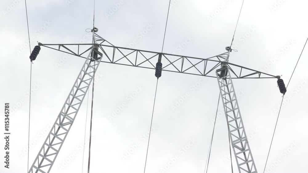 Electric power transmission line in front of cloudy sky 4K 2160p UHD slow tilting footage - Power transmission pole metal construction and wires 4K 3840x2160 UHD slow tilting video Electric power transmission line in front of cloudy sky 4K 2160p UHD slow tilting footage - Power transmission pole metal construction and wires 4K 3840x2160 UHD slow tilting video