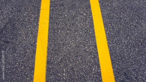 yellow line on street divided between car at parking lot © 4 Girls 1 Boy