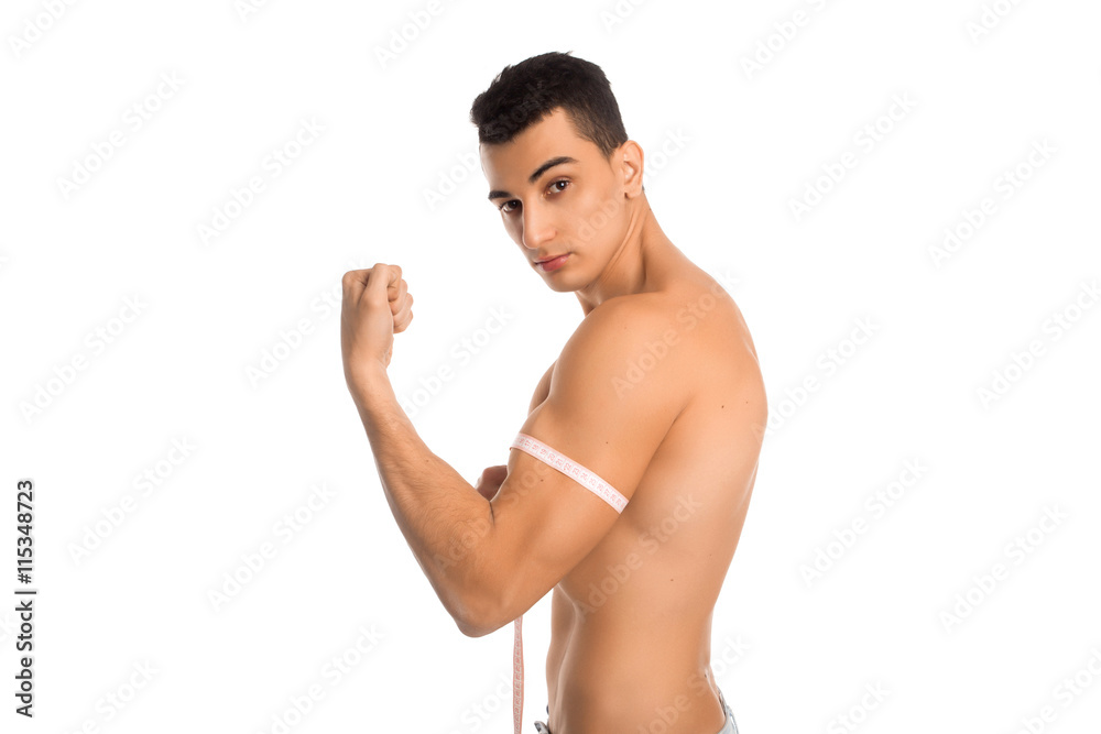 Man measuring biceps in studio Man measuring biceps in studio
