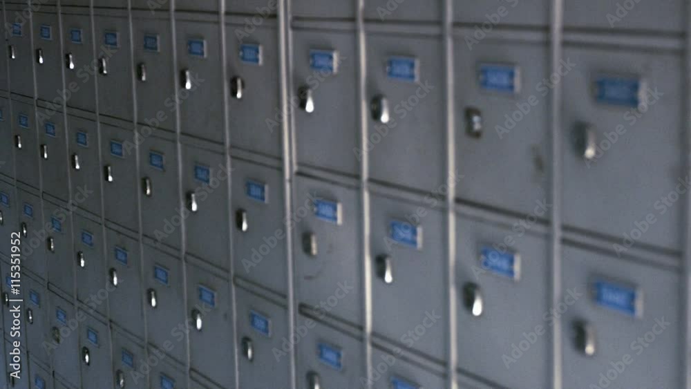 Video 1920x1080 - Continuous, row upon row of identical, gray painted post office boxes with neatly printed numbers and shiny locks. Video 1920x1080 - Continuous, row upon row of identical, gray painted post office boxes with neatly printed numbers and shiny locks.